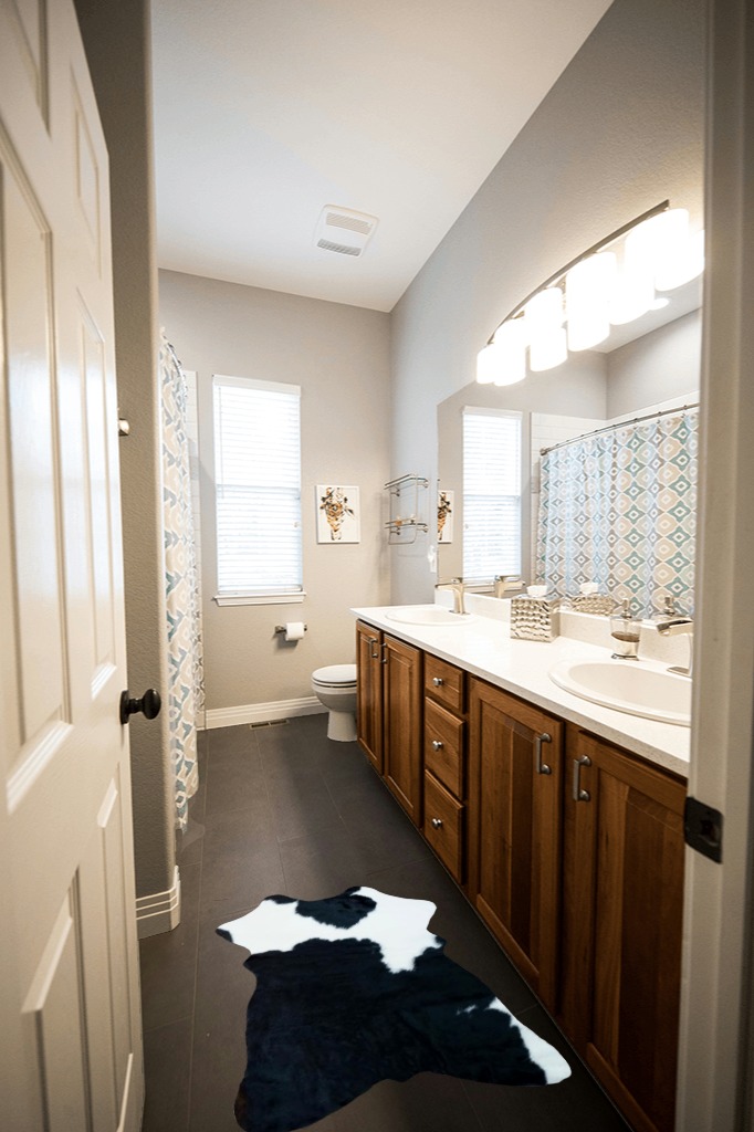 rodeo Genuine Mini Black and White Cowhide Rug Size Approx 2 x 3 ft in Wooden and Grey Bathroom