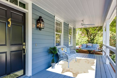 Signature Design by Ashley Jaxith Farmhouse 5 x 7 Medium Pile Cowhide Rug, Ivory & Tan in Light Blue Patio