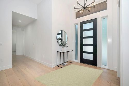 HomeRoots 5' X 7' Green Geometric Power Loom Area Rug in Modern White Entryway