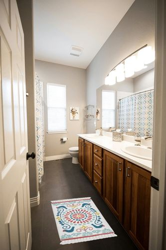 The Pioneer Woman Mazie Medallion Tassel Arctic Cotton Bath Rug - White - 20 x 32 in in Wooden and Grey Bathroom