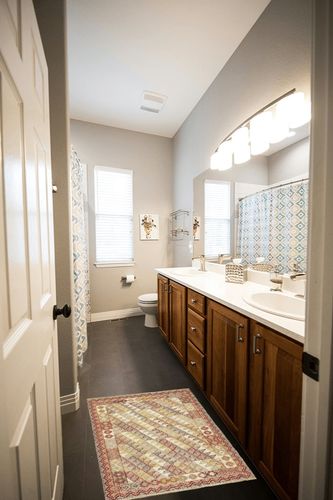 Dash and Albert Alford Handwoven Wool Rug, 2 X 3 Feet, Yellow/Orange/Red Geometric Pattern in Wooden and Grey Bathroom