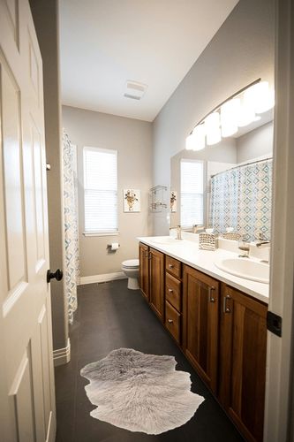 Bloomingville Grey & Off White Dip Dye Tibetan Lamb Fur Rug in Wooden and Grey Bathroom
