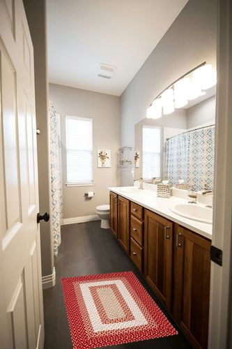 Super Area Rugs Waterbury Braided Rug Handwoven Cotton Washable Rug - Red & Cream, 2' X 3' Rectangle in Wooden and Grey Bathroom