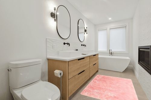 GHOUSE Light Pink 4 ft. x 6 ft. Silky Faux Fur Sheepskin Shag Fluffy Fuzzy Area Rug in Scandinavian Neutral bathroom