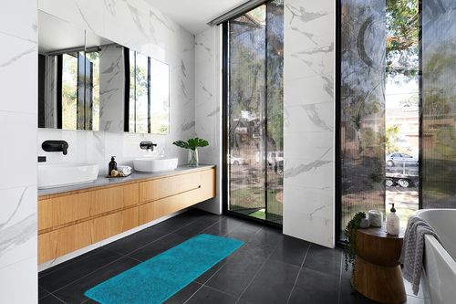 mDesign Non-Slip Microfiber Polyester Rectangular Spa Mat/Bath Rug, Plush Water Absorbent Accent Rug for Bathroom Vanity, Bathtub/Shower, Machine Washable, 60" x 21", Heathered Deep Teal Blue in Modern Black Tiled bathroom