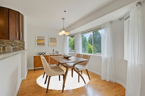 White 6 Ft Round Shag Rug in Modern White Dining Room with Wooden Accents