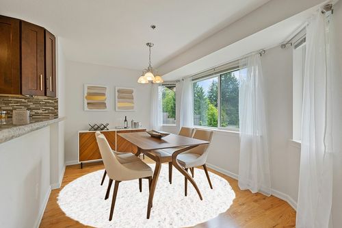 White 8 Ft Round Shag Rug in Modern White Dining Room with Wooden Accents