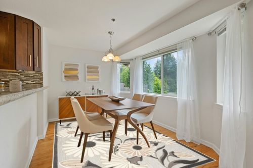 Nourison Aloha Indoor/Outdoor Beige 7' x 10' Area -Rug, Easy -Cleaning, Non Shedding, Bed Room, Living Room, Dining Room, Deck, Backyard, Patio, High Traffic (7x10) in Modern White Dining Room with Wooden Accents