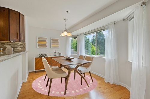 SAFAVIEH Kids Collection Area Rug - 7' Round, Pink, Handmade Wool, Polka Dot Border Design, Ideal for The Living Room, Bedroom, Dining Room, Kids Room, Nursery (SFK802U-7R) in Modern White Dining Room with Wooden Accents