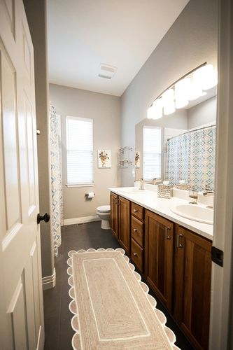 Gautam International Scallop Pattern Jute Bohemian Area Rug (2'x6', Off White) in Wooden and Grey Bathroom