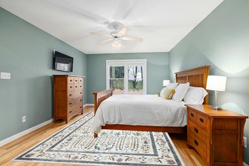 Loloi Rifle Paper Co. x Maison Wisteria Cream 8'-4" x 11'-6" Area Rug in Teal and Orange Wood Bedroom