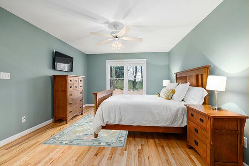Loloi Rifle Paper Co. x Cotswolds Sky 5'-0" x 7'-6" Area Rug in Teal and Orange Wood Bedroom