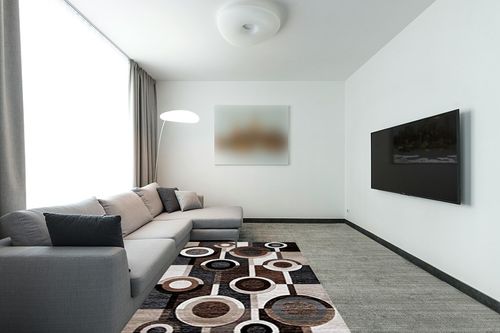 Signature Design by Ashley Guintte Modern 5 x 7 Medium Pile Multilayered Geometric Design Rug, Black, Brown & Cream in Modern Living Room with Grey Couch