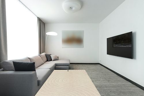 LUXE WEAVERS Modern Geometric Wave Cream 5x7 Area Rug in Modern Living Room with Grey Couch