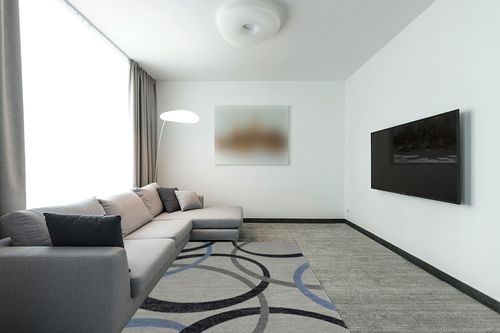 HomeRoots 5' X 7' Ivory Blue and Gray Geometric Area Rug in Modern Living Room with Grey Couch