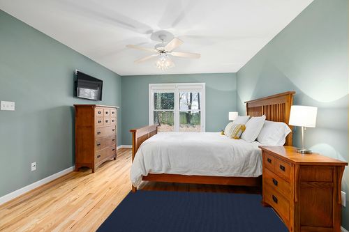 Garland Rug Town Square 4-Feet by 6-Feet Area Rug Navy in Teal and Orange Wood Bedroom