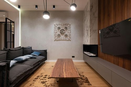 nuLOOM Marcia Machine Washable Faux Cowhide Area Rug, 5' 9" x 7' 7", Brown in Dark Wood Living Room with Black Couch