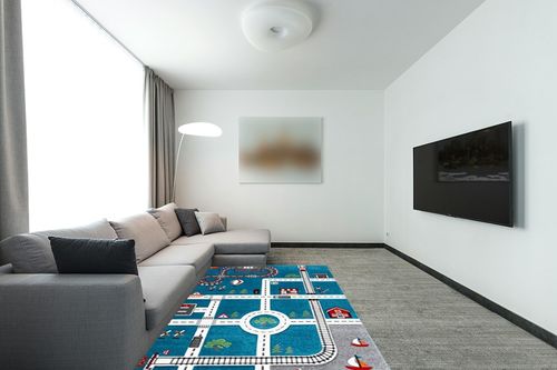 SAFAVIEH Carousel Kids Collection Area Rug - 5'3" x 7'6", Turquoise & Ivory, Non-Shedding & Easy Care, Ideal for High Traffic Areas for Boys & Girls in Playroom, Nursery, Bedroom (CRK192K) in Modern Living Room with Grey Couch