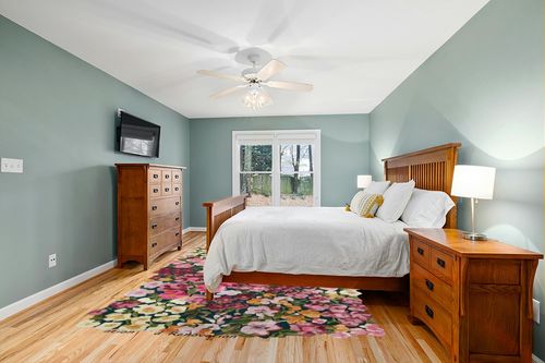 Restoration and Renovation Handmade Colorful Flower Silk & Wool Area Rug | Spring Garden Overflows The Frame | Unique Irregular Shape Hand-Tufted Floral Rug Perfect for Home Decor (5x8 Feet) in Teal and Orange Wood Bedroom