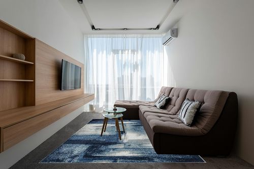 LUXE WEAVERS Contemporary Abstract Navy 8x10 Area Rug in Grey Living Room with Brown Couch