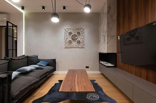 Sunshine Cowhides Genuine Black Cowhide Rug - Luxurious Cow Rug for Bedroom, Living Room, and Home Decor Enthusiasts - Masterpiece of Style and Functionality - 6x6-7ft (180x220cm) in Dark Wood Living Room with Black Couch