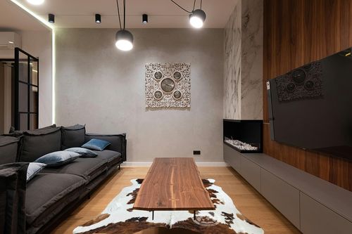 Sunshine Cowhides Genuine Tricolor Cowhide Rug - Luxurious Cow Rug for Bedroom, Living Room, and Home Decor Enthusiasts - Masterpiece of Style and Functionality - 6x6-7ft (180x220cm) in Dark Wood Living Room with Black Couch