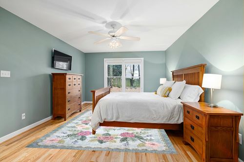 Loloi Rifle Paper Co. x Rosa Sky 7'-6" x 9'-6" Area Rug in Teal and Orange Wood Bedroom
