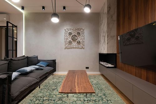 Magnolia Home by Joanna Gaines x Loloi Sinclair Collection SIN-05 Jade / Sand 7'-6" x 9'-6" Area Rug in Dark Wood Living Room with Black Couch