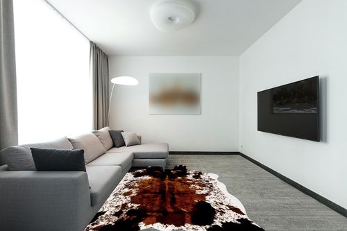 CONBEN Oversized Faux Cowhide Rug (6.3ft x 8.3ft) - Non-Slip Backing, Cow Print Decor - Farmhouse, Western Floor Rugs for Living Room, Bedroom, Dining Area or Office in Modern Living Room with Grey Couch
