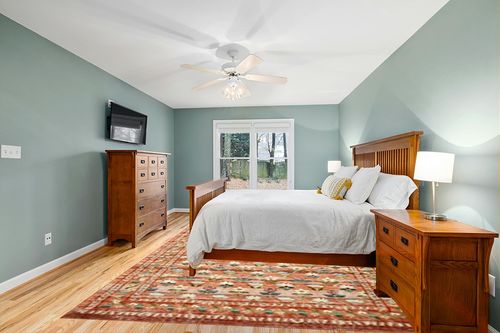 Loloi Rifle Paper Co. x Courtyard Terracotta 8'-6" x 11'-6" Area Rug in Teal and Orange Wood Bedroom