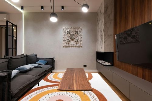 HOMBYS 9x12 Boho Area Rug for Living Room Bedroom, Large Modern Rainbow Floor Carpet with Non-Slip Backing for Indoor Office Dining Room, Home Deco Non-Shedding, Orange, Machine Washable ﻿ in Dark Wood Living Room with Black Couch