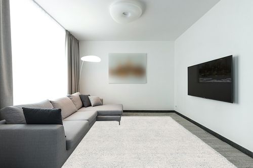 SAFAVIEH Abstract Collection Area Rug - 9' x 12', Ivory & Blue, Handmade Wool, Ideal for High Traffic Areas in Living Room, Bedroom (ABT340M) in Modern Living Room with Grey Couch