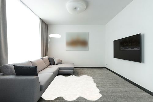 nuLOOM Deonna Faux Sheepskin Shag Area Rug, 5' 3" x 6', White in Modern Living Room with Grey Couch