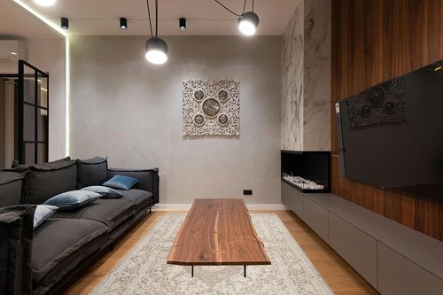 SAFAVIEH Reflection Collection Area Rug - 6' x 9', Beige & Cream, Vintage Distressed Design, Non-Shedding & Easy Care, Ideal for High Traffic Areas in Living Room, Bedroom (RFT664A) in Dark Wood Living Room with Black Couch