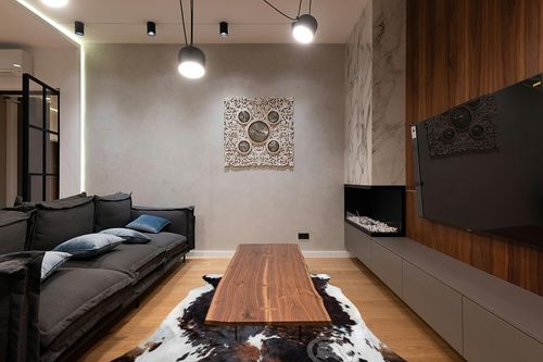 Sunshine Cowhides Genuine Brindle Dark Tricolor Cowhide Rug - Luxurious Cow Rug for Bedroom, Living Room, and Home Decor Enthusiasts - Masterpiece of Style and Functionality - XL 6x7-8ft (180x240cm) in Dark Wood Living Room with Black Couch