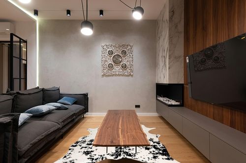 nuLOOM Marcia Machine Washable Faux Cowhide Area Rug, 5' 9" x 7' 7", Black in Dark Wood Living Room with Black Couch