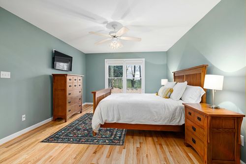 Loloi Rifle Paper Co. x Courtyard Charcoal 5'-0" x 7'-6" Area Rug in Teal and Orange Wood Bedroom