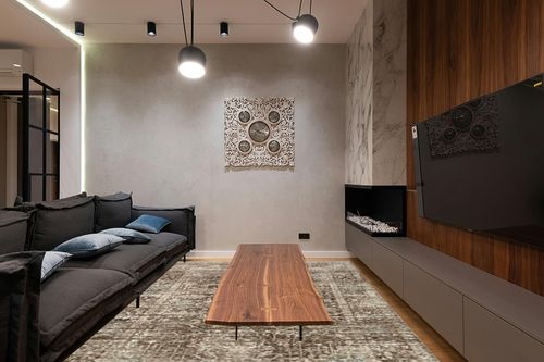 Loloi Magnolia Home by Joanna Gaines x Millie Charcoal/Dove 7'-10" x 10' Area Rug in Dark Wood Living Room with Black Couch