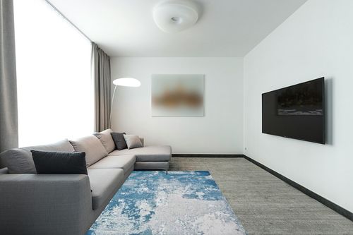 LUXE WEAVERS Abstract Blue 5x7 Area Rug in Modern Living Room with Grey Couch