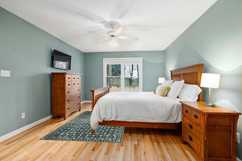 Loloi Rifle Paper Co. x Eden Lattice Indigo 5'-0" x 7'-6" Area Rug in Teal and Orange Wood Bedroom