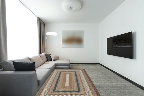 SAFAVIEH Braided Collection Area Rug - 5' x 8', Brown & Multi, Handmade Country Cottage Reversible, Ideal for High Traffic Areas in Living Room, Bedroom (BRD313A) in Modern Living Room with Grey Couch