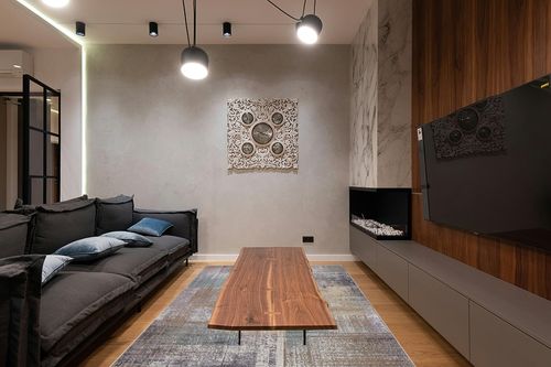 SUPERIOR Washable Indoor Large Area Rug, Modern Abstract Home Floor Decor for Living Room Spaces, Kitchen/Dining, Bedrooms, Office, Dorm, Patchwork Aesthetic, Aria Collection, 6' x 9', Taupe in Dark Wood Living Room with Black Couch