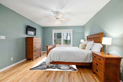 Sunshine Cowhides Genuine Salt and Pepper Longhorn Tricolor Cowhide Rug - Luxurious Cow Rug for Bedroom, Living Room, and Home Decor Enthusiasts - Stylish Masterpiece - 6x7ft (180x210cm) in Teal and Orange Wood Bedroom