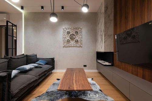 Sunshine Cowhides Genuine Salt and Pepper Cowhide Rug - Luxurious Cow Rug for Bedroom, Living Room, and Home Decor Enthusiasts - Masterpiece of Style and Functionality - 6x7ft (180x210cm) in Dark Wood Living Room with Black Couch