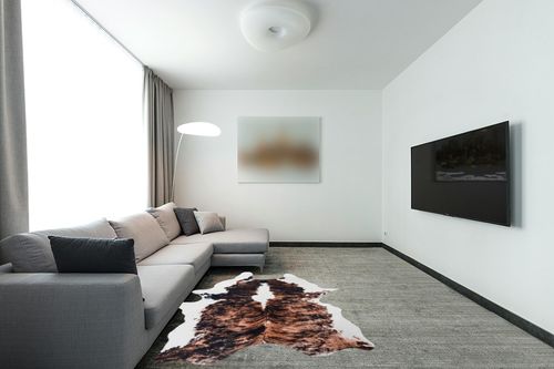 Lahome Faux Cowhide Area Rug - Cow Print Rugs for Living Room Dining Room Bedroom Western Decor, Large Premium Animal Skin Rugs, Cow Hide Print Carpet for Kids Room Nursery, Brown, 62"x75"/5.2'x6.2' in Modern Living Room with Grey Couch