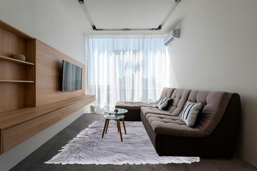 Ultra Soft & Fluffy Faux Sheepskin Rug in Grey Living Room with Brown Couch