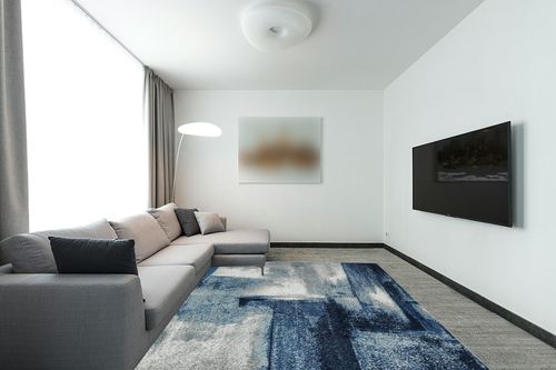 LUXE WEAVERS Contemporary Abstract Navy 8x10 Area Rug in Modern Living Room with Grey Couch