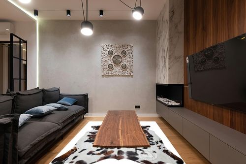 Sunshine Cowhides Genuine Tricolor Spotted Cowhide Rug - Luxurious Cow Rug for Bedroom, Living Room, and Home Decor Enthusiasts - Masterpiece of Style and Functionality - 6x6-7ft (180x210cm) in Dark Wood Living Room with Black Couch