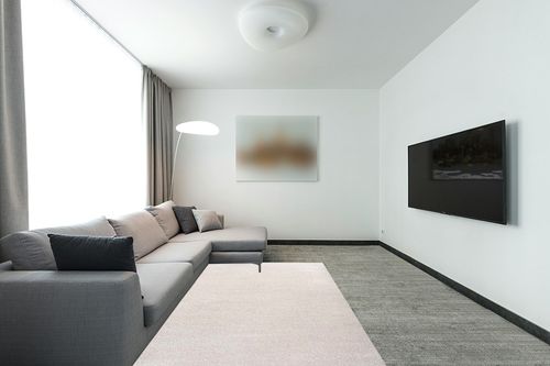 JONATHAN Y SEU100D-5 Haze Solid Low-Pile Indoor Area-Rug Casual Contemporary Solid Traditional Easy-Cleaning Bedroom Kitchen Living Room Non Shedding, 5 ft x 8 ft, Ivory in Modern Living Room with Grey Couch