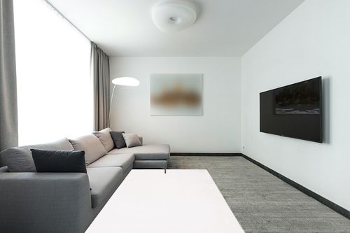 SAFAVIEH Faux Rabbit Fur Collection Area Rug - 5' x 7', Off White, Solid Design, Non-Shedding Machine Washable & Slip Resistant Ideal for High Traffic Areas in Living Room, Bedroom (FRF500A) in Modern Living Room with Grey Couch